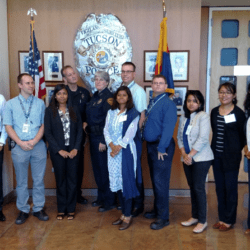 A group of people standing in front of a police office.