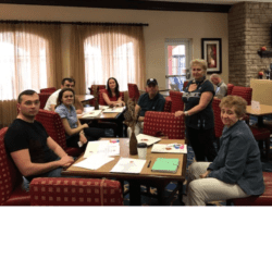 A group of people sitting around a table.