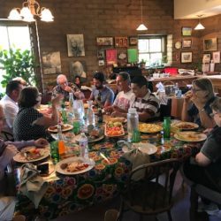 A group of people sitting at a table eating.