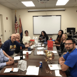 A group of people sitting around a table.