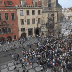 A crowd of people walking on the street.