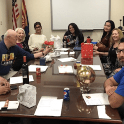 A group of people sitting around a table.