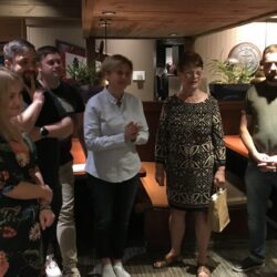 Group of people standing in a restaurant.