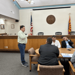 Meeting in a conference room with flags.