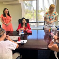 A group of people sitting around a table.